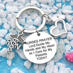 Detail view of nurse's prayer keychain with RN medical symbol and heart-shaped pendant
