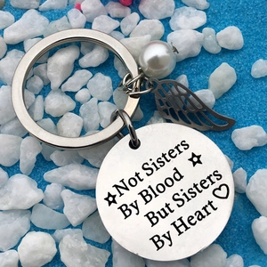 Stainless steel friendship keychain with Not Sisters By Blood engraving and wing charm
