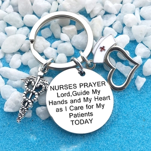 Polished stainless steel nurse prayer keychain with medical caduceus and nurse hat charms