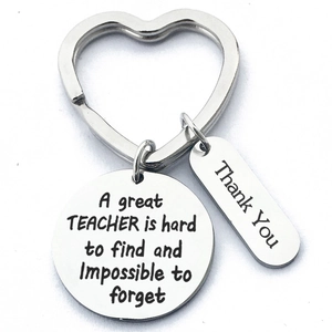 Close-up of stainless steel teacher gift keychain with heart ring and engraved tags