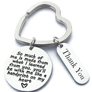 Close-up of stainless steel heart-shaped keyring with engraved emotional pendants