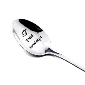 Polished stainless steel spoon with spread knowledge engraving and book icon