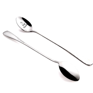 Macro view of mirror polished stainless steel spoon with Best Teacher engraved text