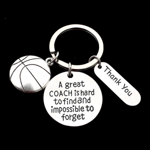 Close-up of engraved stainless steel basketball coach keychain with inspirational text