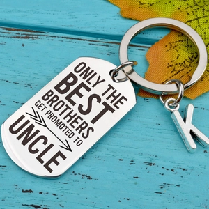 Polished stainless steel keychain with engraved quote and a metal letter K pendant