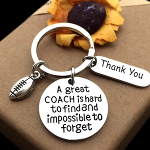Macro detail of coach appreciation keychain with football charm and engraved thank you message