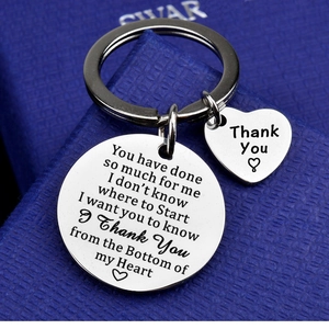 Polished stainless steel keychain with laser-engraved round and heart pendants in a gift box