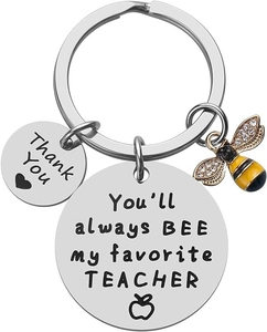 Close-up of stainless steel teacher keychain with bee charm and engraved quotes