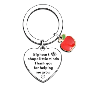 Teacher appreciation keychain with heart charm and red apple pendant on white background