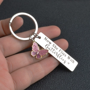 Detail of memorial keychain with butterfly pendant and engraved memorial message