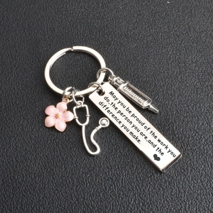 Medical themed keychain with pink flower, stethoscope, and engraved motivational tag