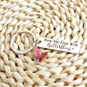 Memorial stainless steel keychain with Now She Flies With Butterflies text and pink butterfly
