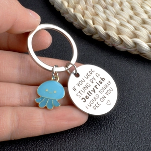 Cute blue jellyfish keychain with humorous friendship quote on round silver charm