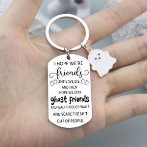 Close-up of stainless steel ghost keychain with friendship quote and white ghost charm
