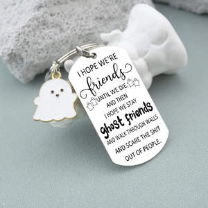 Detail of stainless steel friendship keychain with ghost charm and engraved message