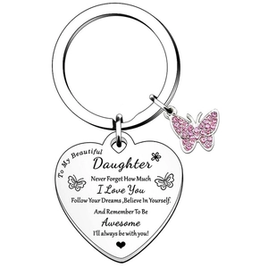Close-up of heart keychain for daughter with engraved text and pink crystal butterfly