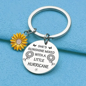 Detail of sunflower keychain with engraved text She's sunshine mixed with a little hurricane