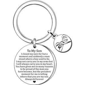 Detail view of silver stainless steel keychain with engraved quote and pinky swear charm