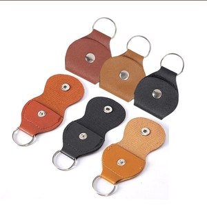 Detailed view of leather guitar pick holders in dark brown, light brown, and black colors