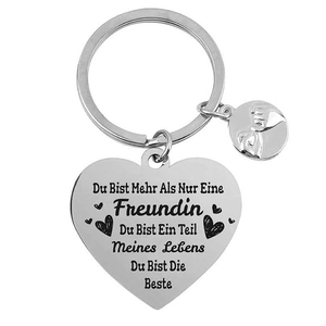 Detail of silver heart keychain featuring German text and engraved circular pendant tag