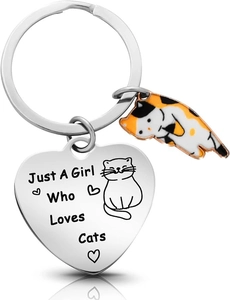 Detail of heart keychain with engraved text and a small colorful enamel cat pendant