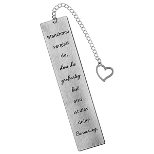 Macro view of brushed stainless steel bookmark with German text and heart charm