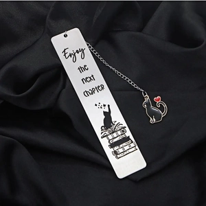 Cat tassel bookmark in stainless steel featuring Enjoy the next chapter text and cat charm