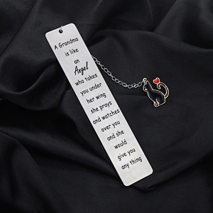 Detailed macro view of an engraved stainless steel bookmark with a black cat enamel charm