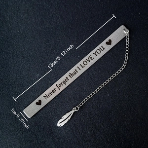 Stainless steel bookmark with I LOVE YOU engraving and feather charm on black background