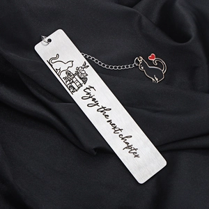 Detail of stainless steel cat bookmark with tassel and Enjoy the next chapter engraving