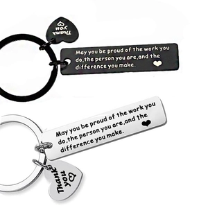 Detail of stainless steel keychains with heart charm and motivational gratitude engraving