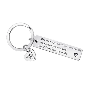 Close-up of engraved stainless steel keychain with motivational quotes and thank you charm