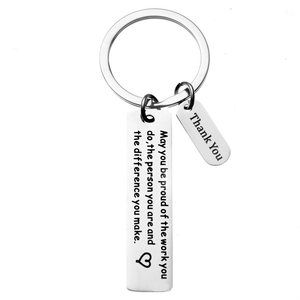 Close-up of engraved stainless steel keychain with thank you charms and heart details