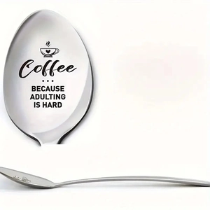 Detail of laser engraved stainless steel coffee spoon with Coffee Because Adulting Is Hard text