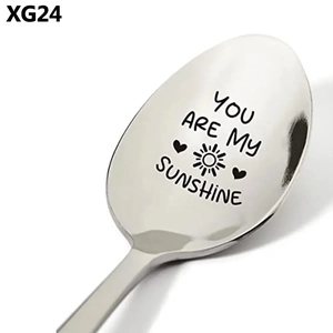 Detailed close-up of polished stainless steel spoon engraved with You Are My Sunshine