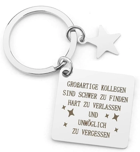 Macro detail of engraved stainless steel keychain with square tag and star charm