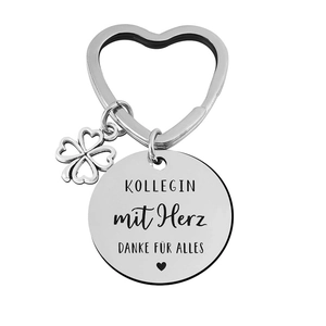 Detailed macro view of heart-shaped stainless steel keychain with clover and German engraving