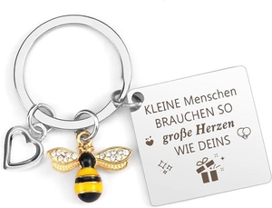 Detail of engraved teacher keychain with gold bee, hollow heart, and German text charm