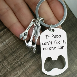 Father's Day stainless steel bottle opener keychain with mini tool charms on wood backdrop