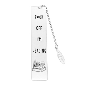 Macro shot of stainless steel bookmark with chain, feather charm and engraved reading slogan