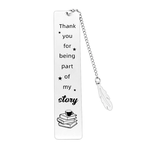 Macro shot of stainless steel bookmark with engraved quote and a silver feather pendant
