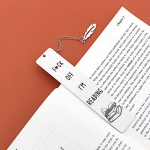 Polished stainless steel bookmark with feather charm and humorous engraved reading quote
