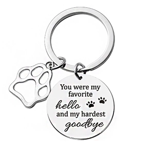 Polished stainless steel pet memorial keychain with engraved sentimental quote and paw charm