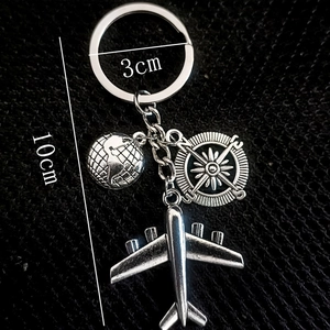 Travel theme keychain with earth, plane and compass charms measuring 10cm total length