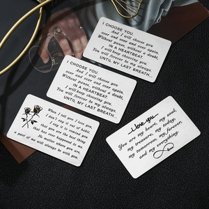 Macro shot of brushed stainless steel wallet insert card with engraved romantic quotes