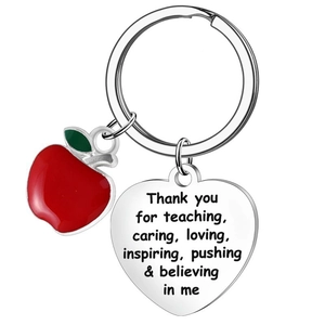 Detailed view of polished heart pendant with teacher appreciation text and red enamel apple