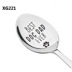 Macro view of stainless steel spoon engraved with Best Dog Dad Ever and a heart paw print