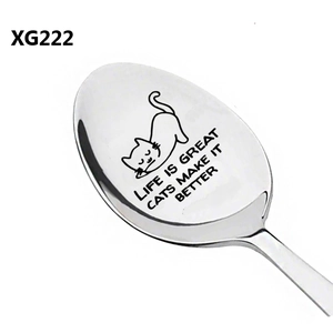 Macro detail of stainless steel spoon featuring Life Is Great Cats Make It Better engraving