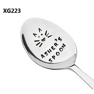 Close-up of laser engraved cat icon and personal text on polished stainless steel spoon