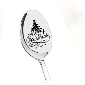 Macro shot of laser engraved Merry Christmas text and tree on stainless steel spoon